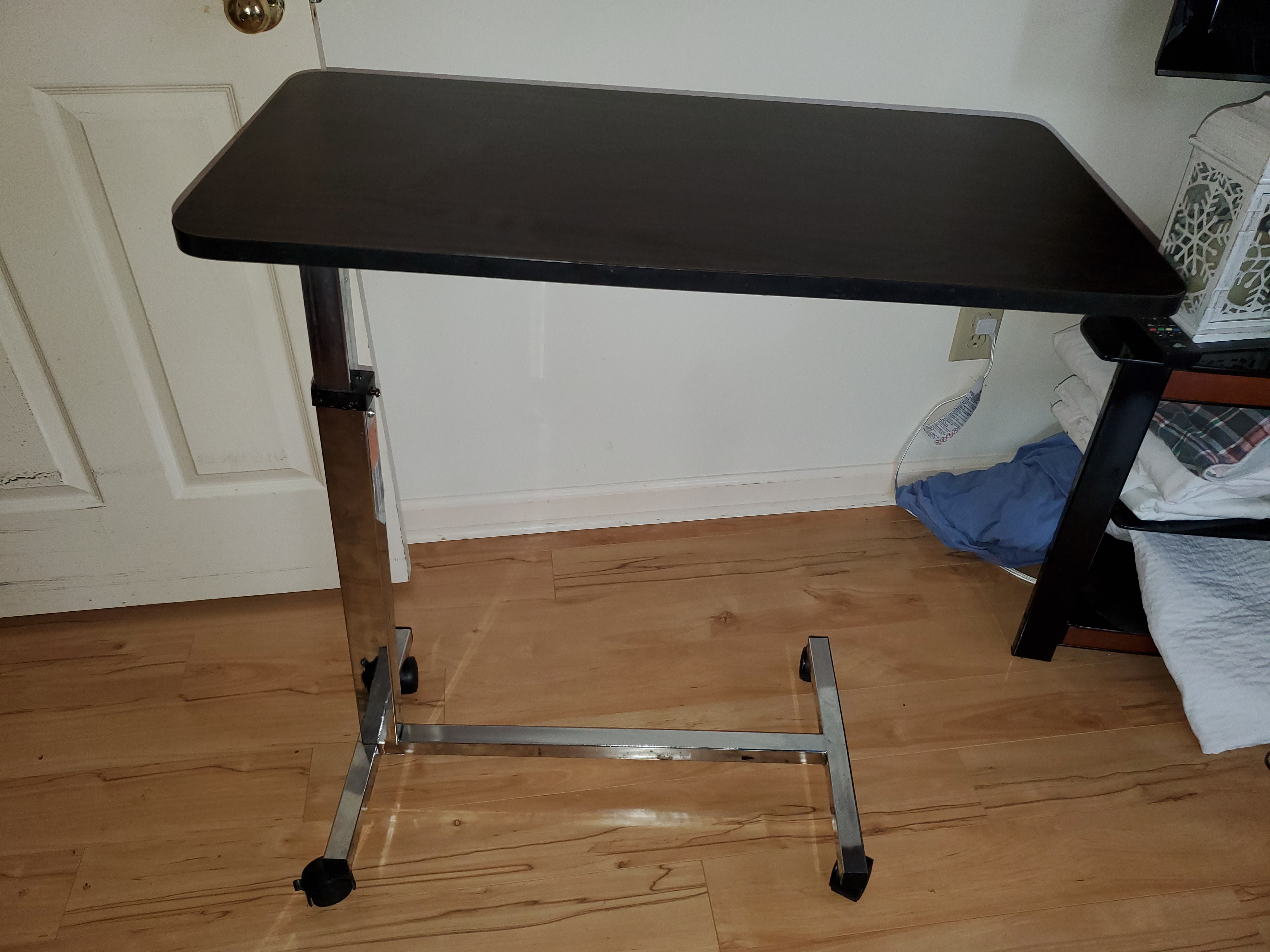 Photo 2 of adjustable hospital bedside table on wheels